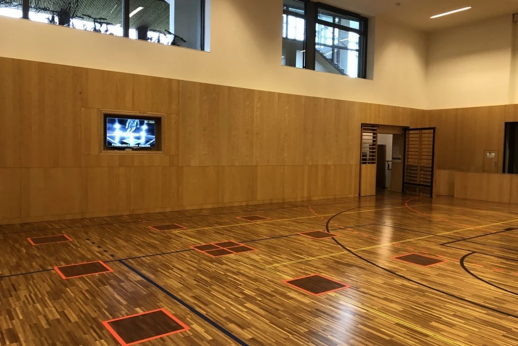 Паркетный спортзал со встроенными в пол сенсорами SpeedCourt и экраном